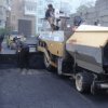 The first layer of asphalt pavement is laid and